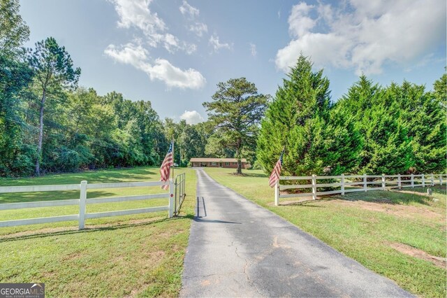 back of property with a lawn and a wooden deck