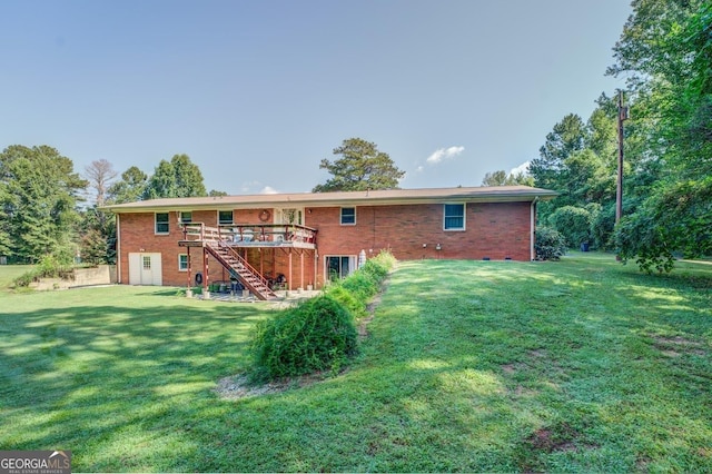 rear view of property featuring a deck and a lawn