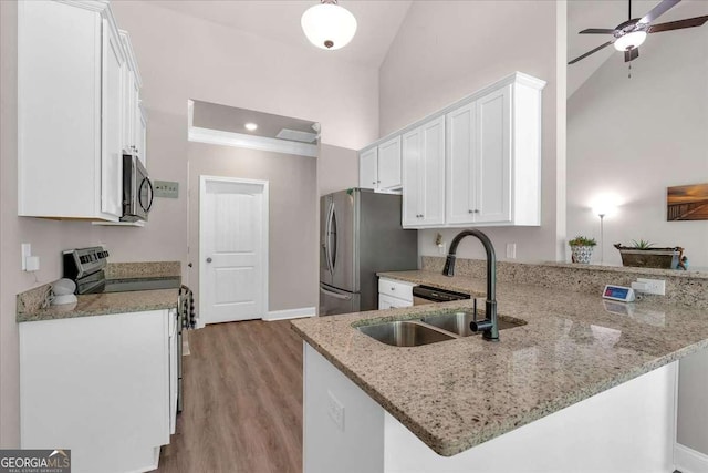 kitchen with white cabinetry, sink, kitchen peninsula, and stainless steel appliances