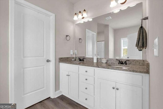 bathroom with hardwood / wood-style floors and vanity