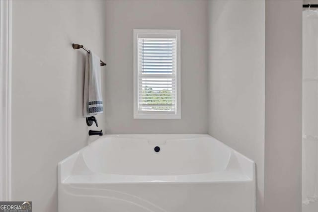 bathroom with a tub to relax in