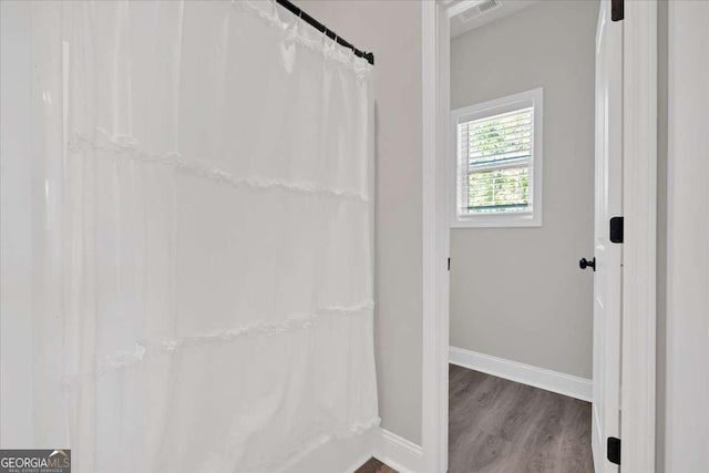 bathroom with wood-type flooring