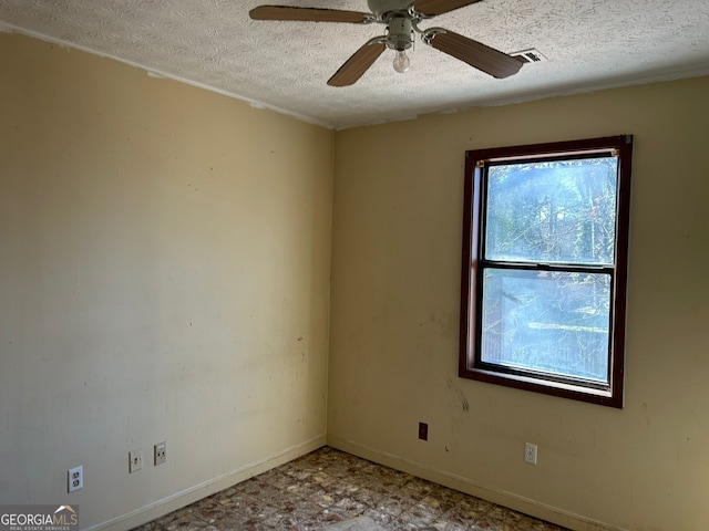 spare room featuring ceiling fan and a textured ceiling