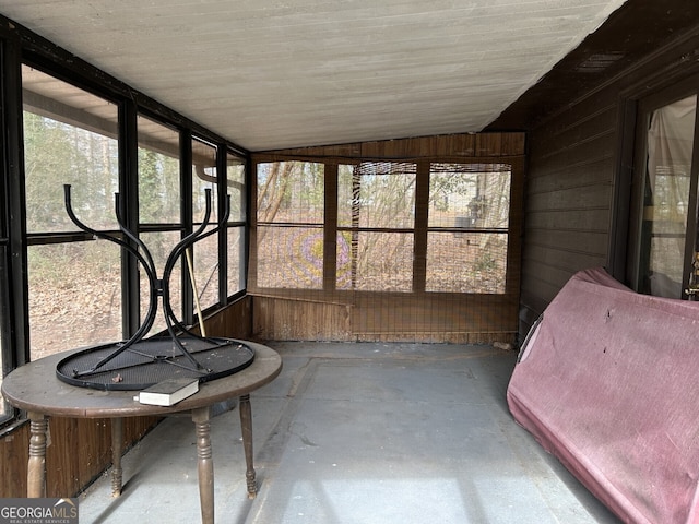 sunroom featuring a wealth of natural light and vaulted ceiling