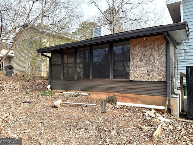 view of property exterior with a sunroom