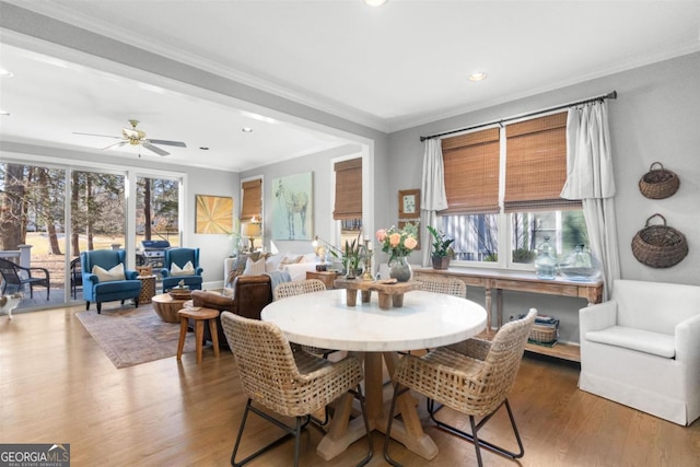 dining area featuring hardwood / wood-style flooring, ceiling fan, a healthy amount of sunlight, and ornamental molding