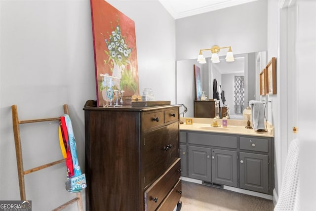 bathroom featuring crown molding and vanity