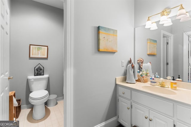 bathroom featuring tile patterned flooring, vanity, and toilet