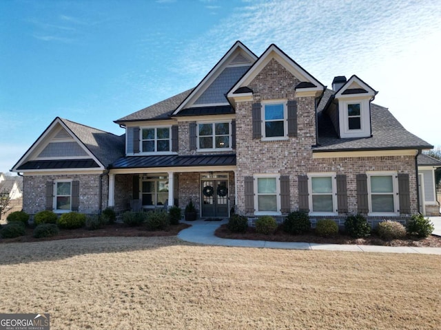 craftsman-style home featuring a front lawn and covered porch