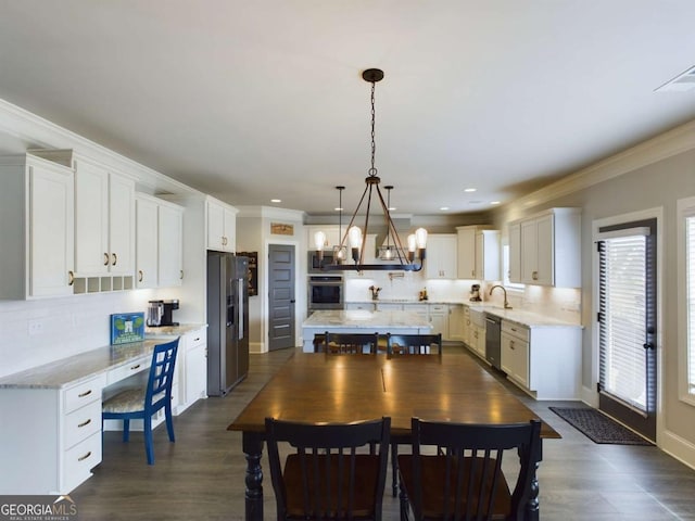 dining space featuring crown molding, sink, and dark hardwood / wood-style floors