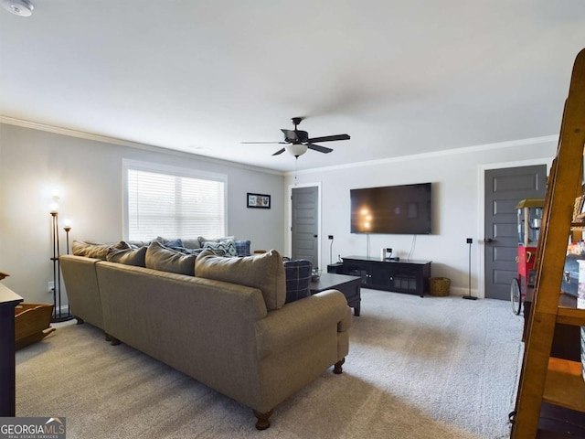 carpeted living room featuring ceiling fan and ornamental molding