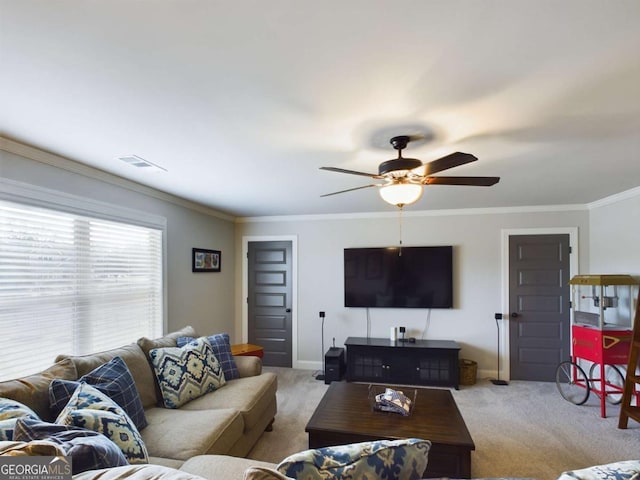 living room with ceiling fan, light colored carpet, and ornamental molding