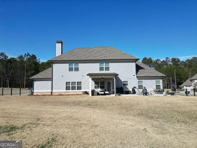 back of house with a lawn, outdoor lounge area, and a patio