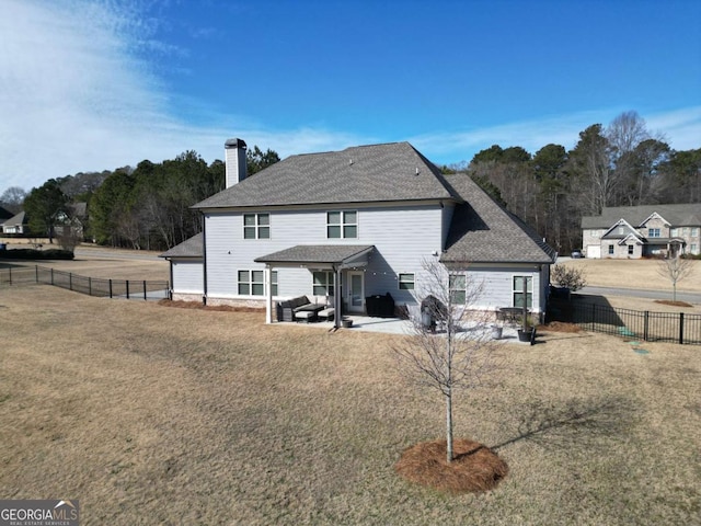 back of property featuring a lawn, an outdoor living space, and a patio