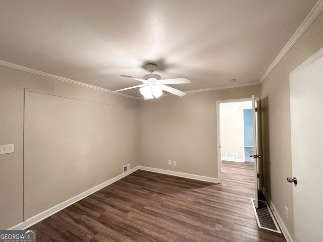 spare room featuring dark hardwood / wood-style flooring, ceiling fan, and crown molding