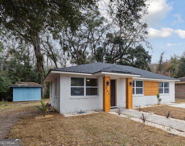 view of front facade featuring a storage shed