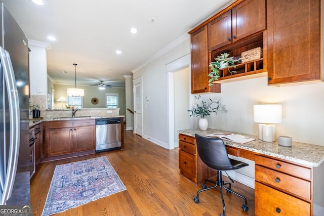 kitchen with ceiling fan, hanging light fixtures, stainless steel appliances, light stone counters, and kitchen peninsula