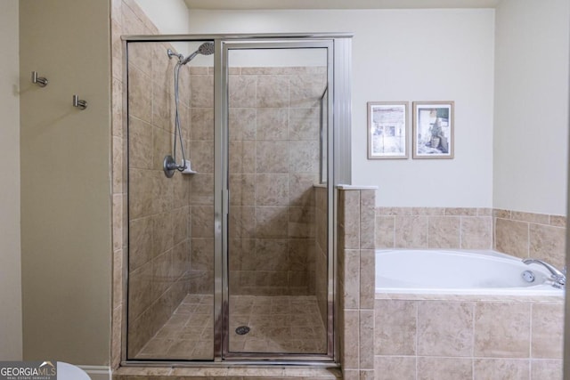 bathroom featuring separate shower and tub