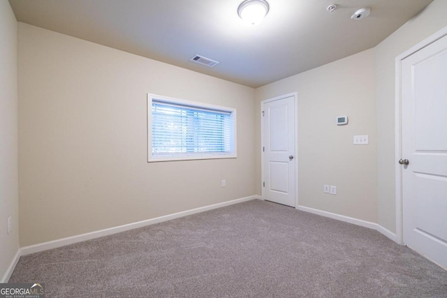 unfurnished room with light colored carpet