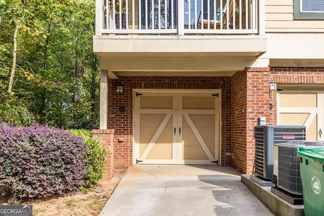 doorway to property featuring a balcony and cooling unit