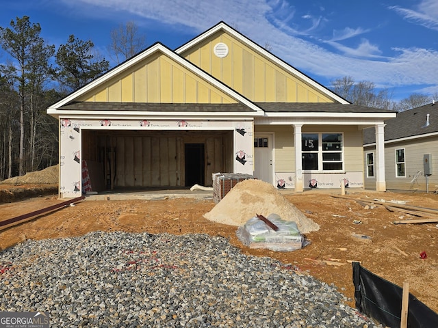 view of front of home featuring covered porch and a garage