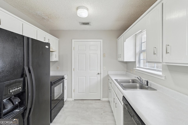 kitchen featuring black appliances, a sink, light countertops, and white cabinetry