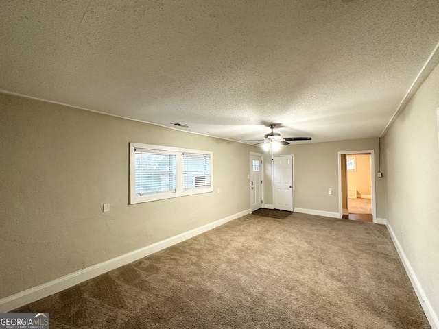 carpeted empty room featuring a textured ceiling and ceiling fan