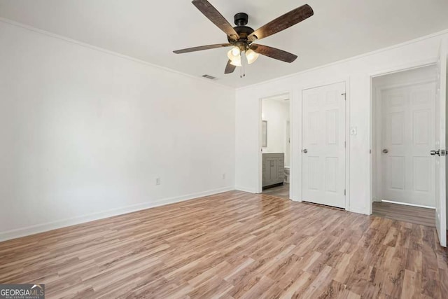 unfurnished bedroom featuring ceiling fan, light hardwood / wood-style floors, ornamental molding, and ensuite bath