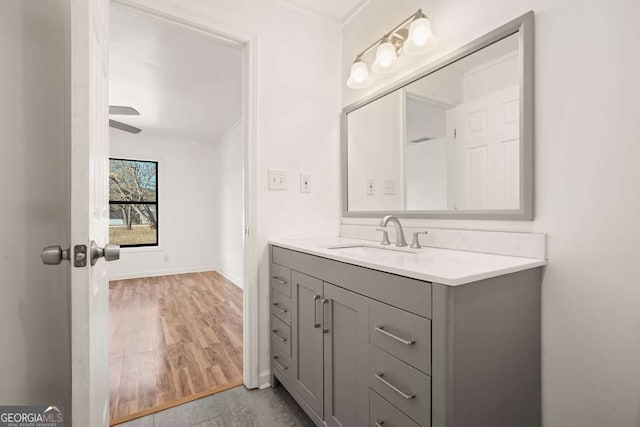 bathroom with vanity, hardwood / wood-style flooring, and ceiling fan