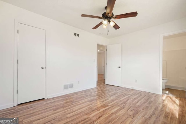 unfurnished bedroom featuring a closet, ensuite bathroom, ceiling fan, and light hardwood / wood-style floors