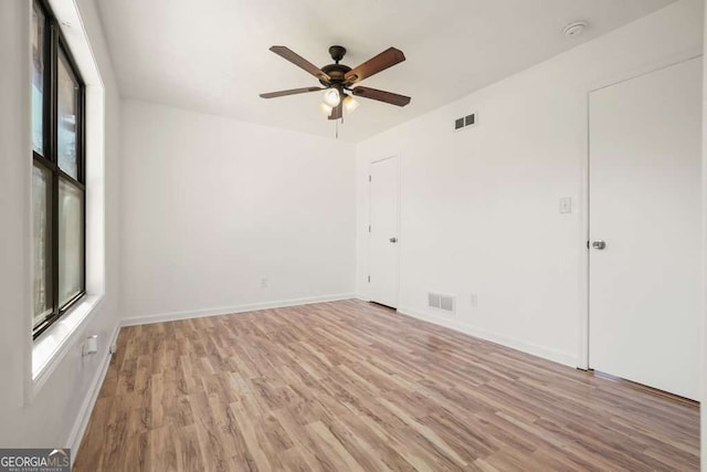 unfurnished room with ceiling fan and light wood-type flooring