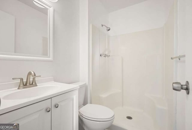 bathroom with vanity, toilet, and walk in shower