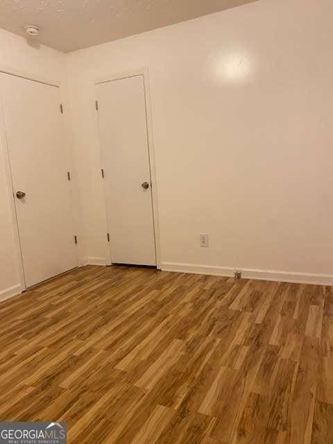 unfurnished room with hardwood / wood-style floors