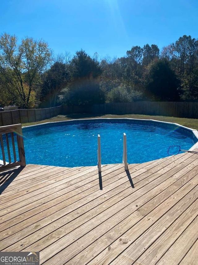 view of pool with a wooden deck