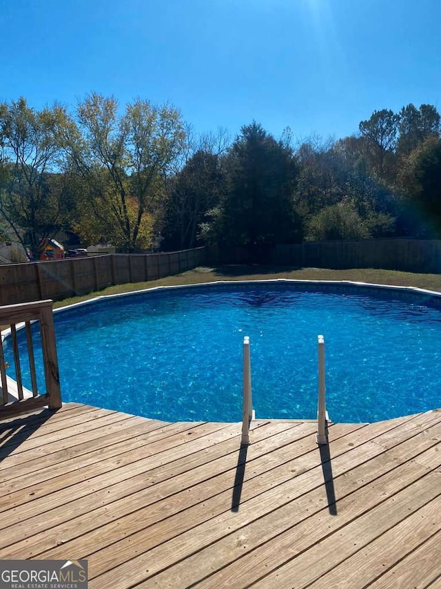 view of swimming pool featuring a wooden deck