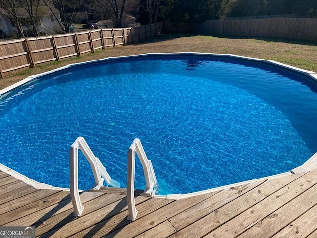 view of pool with a wooden deck