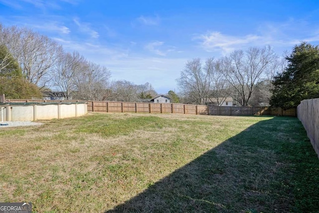 view of yard with a covered pool