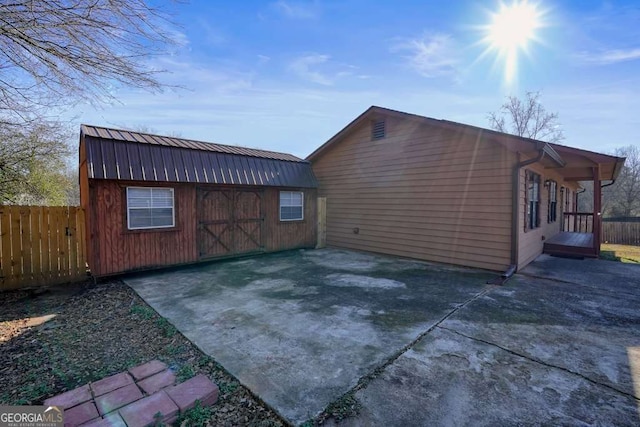 exterior space with a storage shed and a patio area