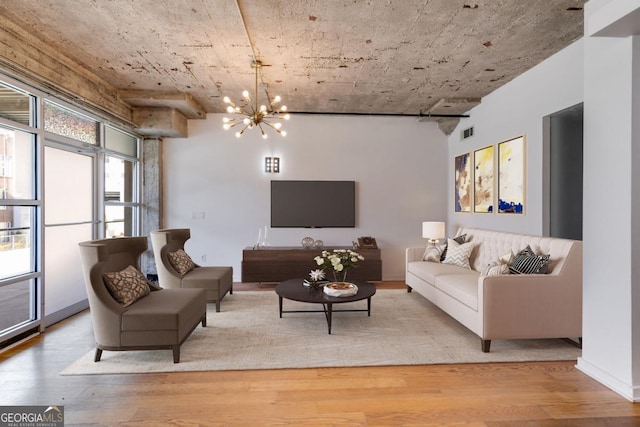 living room featuring light hardwood / wood-style flooring and an inviting chandelier