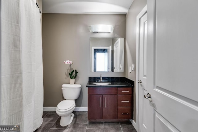 bathroom featuring tile patterned flooring, vanity, and toilet