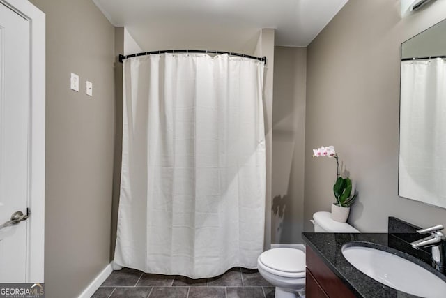 bathroom with tile patterned flooring, vanity, and toilet