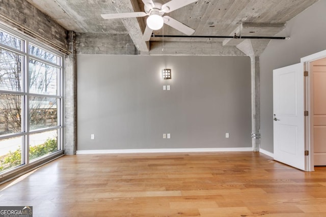 spare room with ceiling fan, light wood-type flooring, and a wealth of natural light