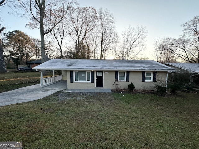 single story home featuring a lawn and a carport