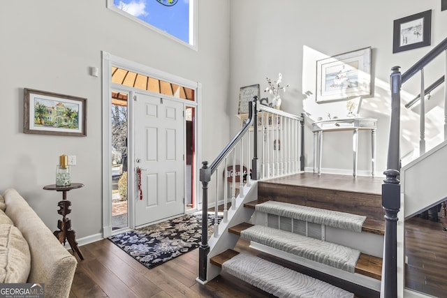 entrance foyer with a high ceiling and dark hardwood / wood-style floors