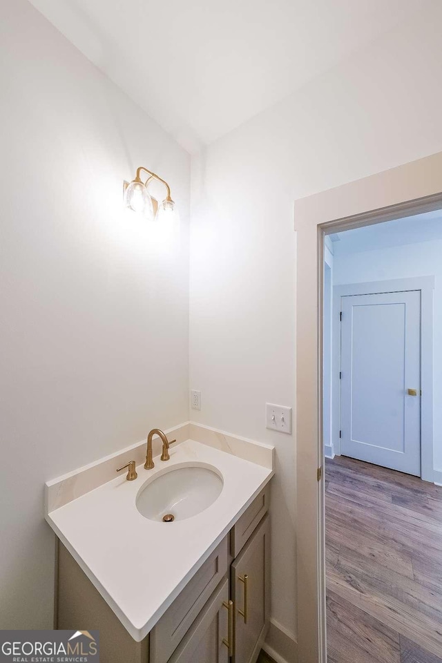 bathroom with hardwood / wood-style floors and vanity