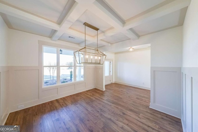 unfurnished living room featuring beam ceiling, a chandelier, wood-type flooring, and coffered ceiling