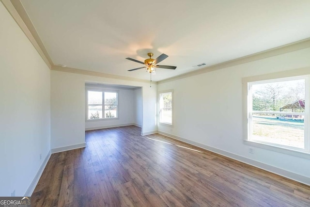 unfurnished room featuring crown molding, ceiling fan, and dark hardwood / wood-style floors