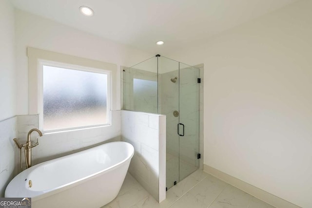 bathroom with shower with separate bathtub