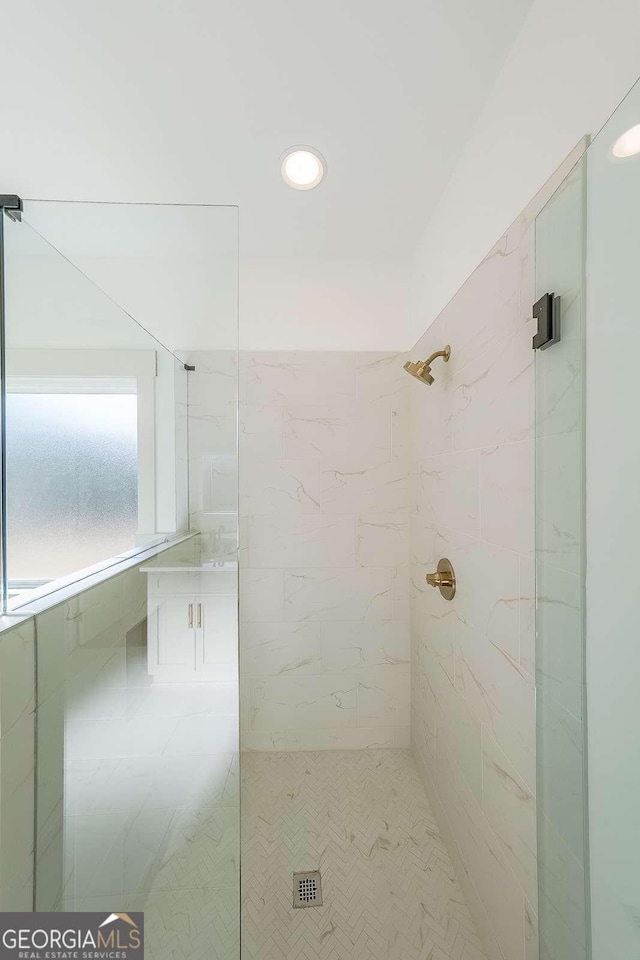 bathroom with a tile shower