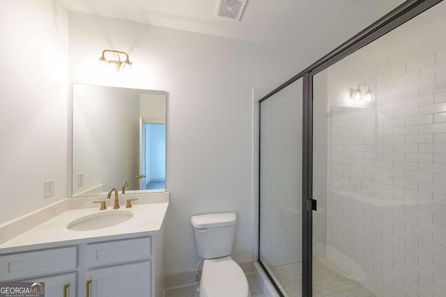 bathroom with vanity, toilet, and walk in shower